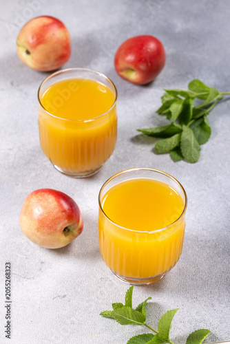 Фотография Fresh nectarine juice invigorating summer drink on grey background
