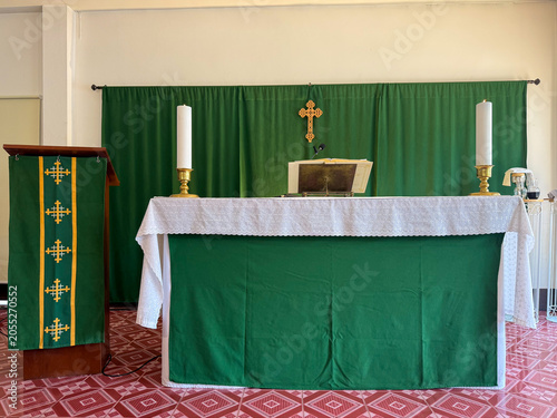 Fotografie Church altar table with green paraments and candles