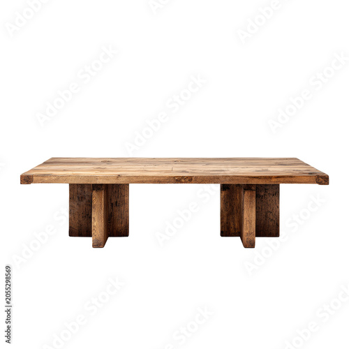 A large, rectangular, rustic wooden table. It features a thick, solid surface supported by block legs. The wood grain is visible