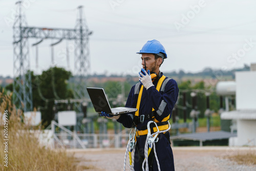 Canvas Print Electrical technicians are inspecting the operation and power distribution system within the substation that receives energy from the wind farm