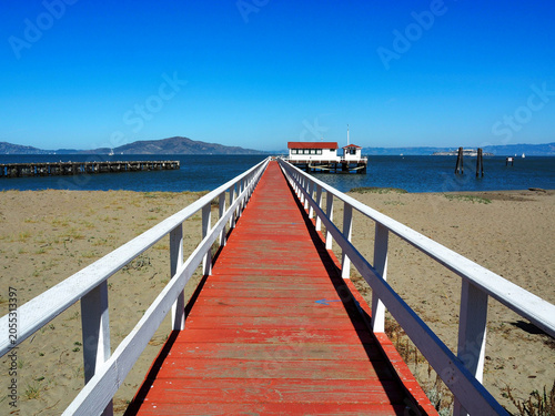 San Francisco, California, 08/10/2018 Description: Red wooden pier leading to the San Francisco Bay