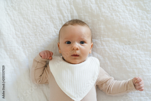 Fotografie Portrait of a two to three month old baby with visible drool on lips