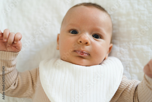 Quadro su tela Portrait of a two to three month old baby with visible drool on lips