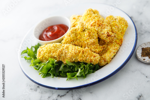 Chicken stipes with tomato sauce