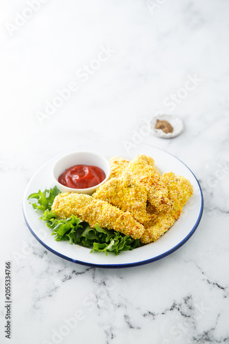 Chicken stipes with tomato sauce