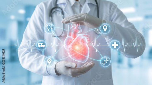 Medical expert protecting a glowing digital human heart hologram with healthcare icons in a modern hospital setting for cardiology research