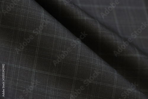 Foto Grid check pattern defines this elegant charcoal black cashmere suiting fabric, perfect for luxury menswear fashion, tailoring textile backgrounds, and high-end bespoke apparel design texture