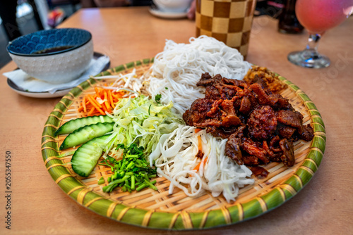 Vietnamese meal Bun cha on decorative plate on table.