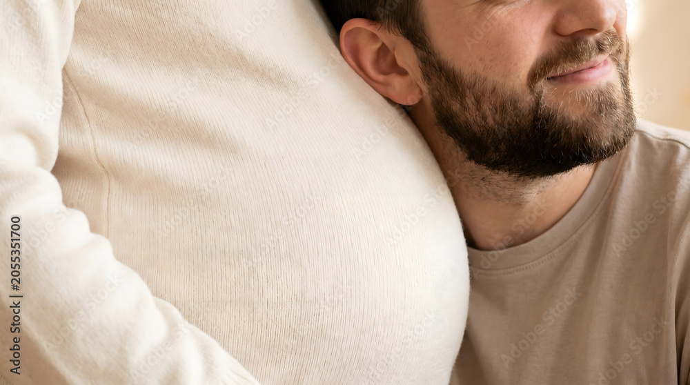 Fototapeta premium Man gently resting his head on pregnant woman's belly in a warm intimate moment