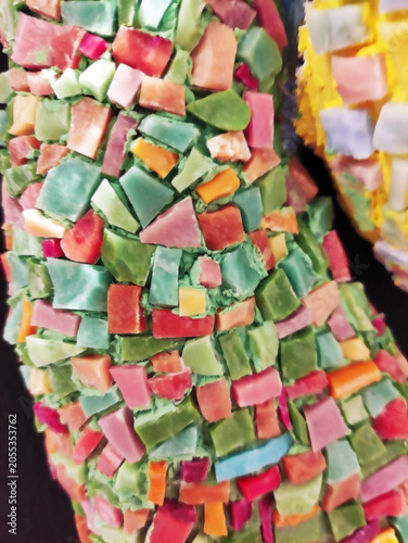 Close-up of a colorful mosaic made of ceramic fragments. Abstract texture, decorative art, handmade craftsmanship, detailed mosaic pattern.