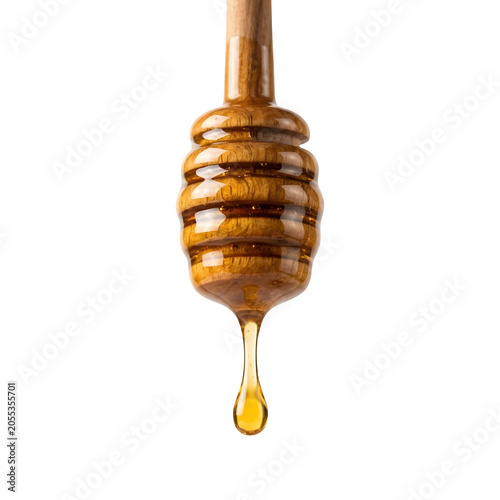 Honey dripping from a wooden honey dipper isolated on transparent background