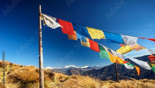 Weathered Prayer Flags Flutter Against A Clear Blue Sky