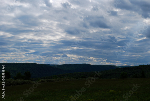 Sky covered in clouds with landscape in the horizon 