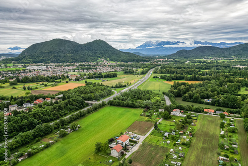 Photography A scenic aerial drone view looking over the Brod district in Ljubljana, Slovenia, with the prominent double-peaked Smarna Gora hill rising in the mid-ground