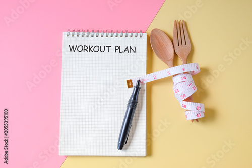 A tape measure wrapped in Wooden fork and spoon,concept of lose weight.