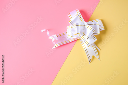 White ribbon on  two tone background.