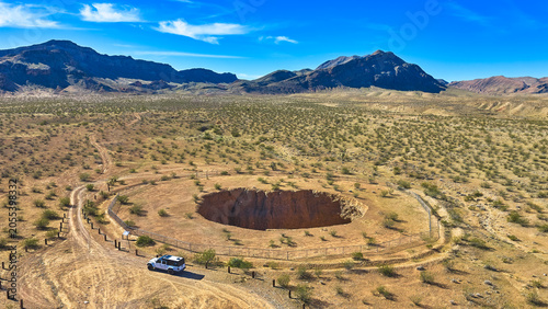 Aerial Devil's Throat Sinkhole Jeep and Desert Landscape Nevada