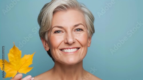adult positive woman with an autumn leaf