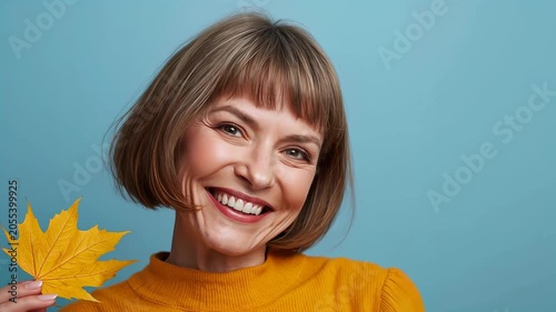 adult positive woman with an autumn leaf
