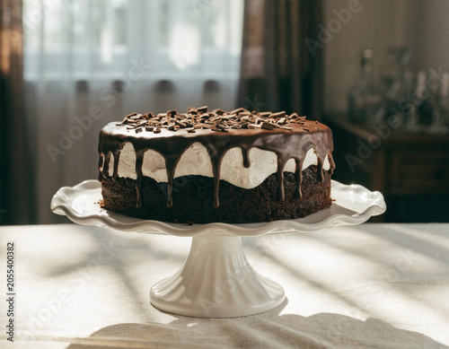 Chocolate Cake with White Frosting on Pedestal