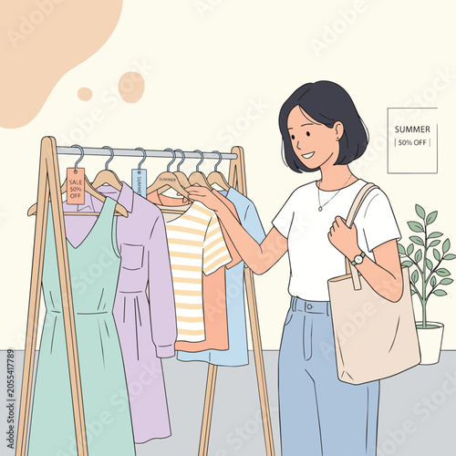 A young woman with short dark hair and a white t-shirt is looking at clothes on a rack, holding a tote bag and a watch on her wrist.