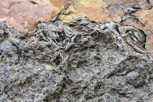 Fotografie Macro View of a Geological Specimen with Mica Embedded in Quartz with Oxides and