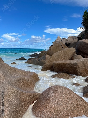 The beautiful Grand Ance Beach on La Digue Island in the Seychelles. Turquoise sea, waves, huge cliffs, white sand
