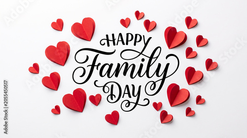 Happy Family Day typography surrounded by red 3D paper hearts on white background.