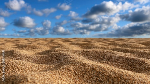 Golden sand dunes meet a vast, cloudy blue sky on a clear day