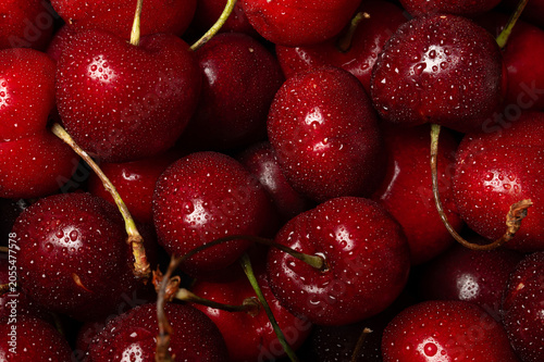 Fresh sweet cherries with water drops, juicy summer fruit macro background