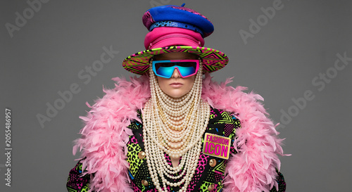 Overdressed fashion character layered with clashing accessories in a satirical style icon portrait exploring terrible taste and excess
