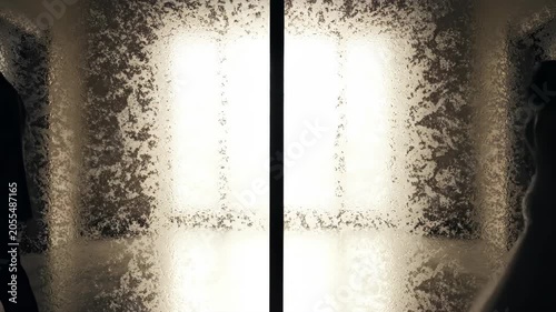 Silhouettes of a couple in formal wear standing apart with textured abstract background