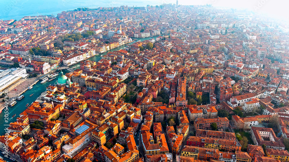 Obraz premium Aerial drone view of Venice historic terracotta rooftops, dense Renaissance architecture and canals, Venice, Veneto, Italy