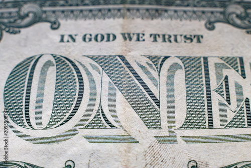 Extreme macro close-up of one dollar bill with in god we trust motto