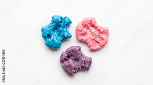 Three pieces of colorful chewing gum with teeth marks
