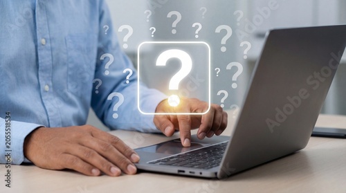 Curious cat sitting near laptop with question marks floating above, showcasing digital kitty while thinking for modern cats