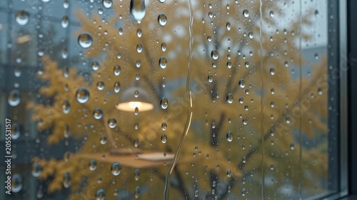 Slow motion heavy raindrops sliding down office window glass