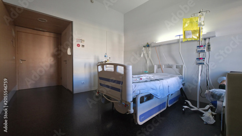 Hospital room with empty bed and medical equipment