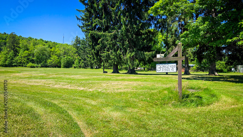 Golf course fairway hole 3 sign with distance and par