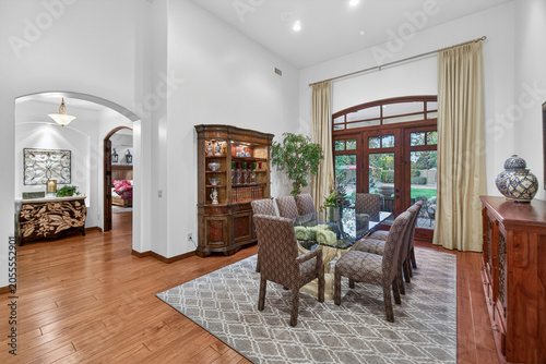 Spacious dining room with arched doorway and large windows