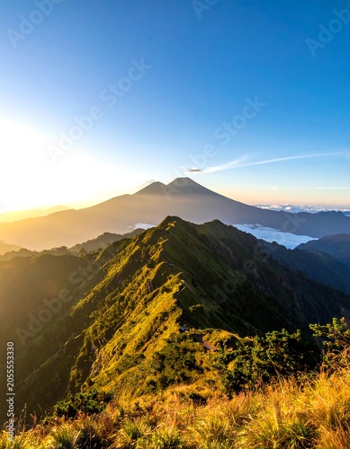 Majestic sunrise over a mountain range with distant peak