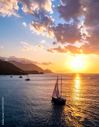 Majestic sunset over calm ocean with sailboats