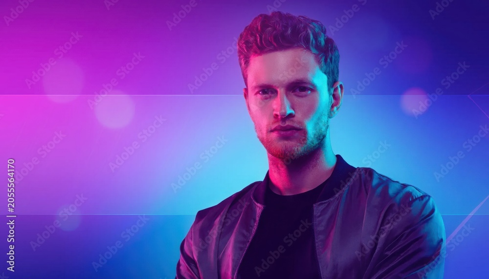 Fototapeta premium Young Man With Intense Expression in Vibrant Neon Light Background