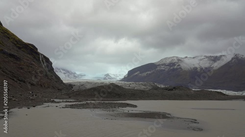 Moody Jokulsarlon glacier with overcast sky and mountains in view