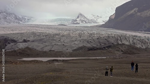 Visiting Jokulsarlon glacier with tourists on a moody day in Iceland