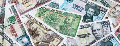 Fotografie Cuban peso money banknotes pile on table