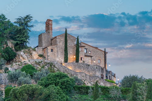 Medieval stone village and church at dusk in Castiglione d'Orcia, Tuscany, Italy