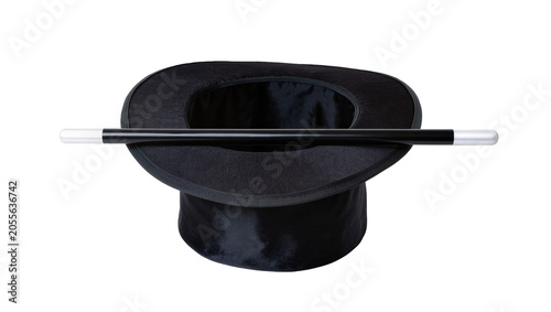 Fotografie Black magician s top hat with magic wand resting across the brim, isolated on tr