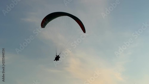 Tandem paragliding at the sunset
