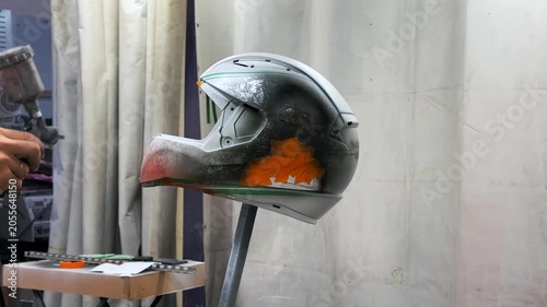 airbrushing a red motorcycle helmet